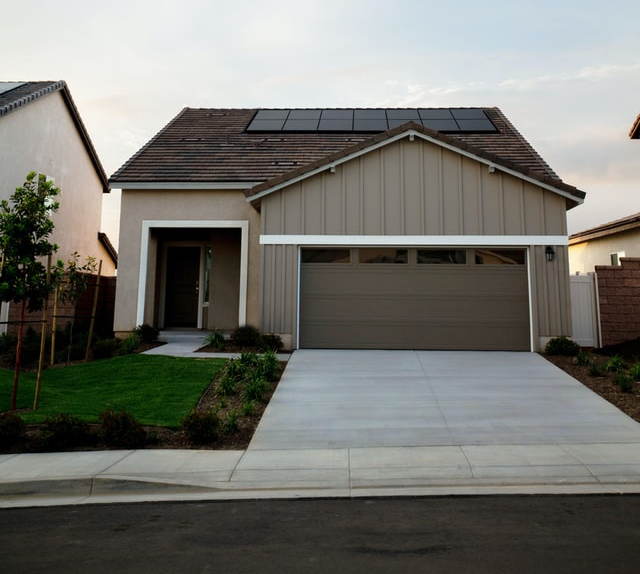 Solar Panels on small home with driveway from street